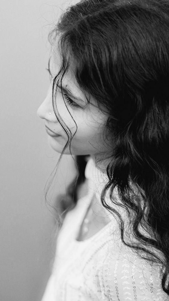 Woman in profile with soft, wavy hair