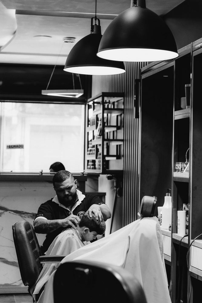 Barber finishing a man's haircut