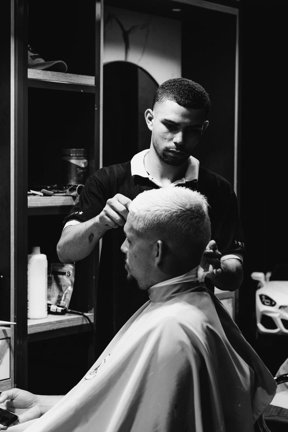 Barber cutting a man's bleached crop