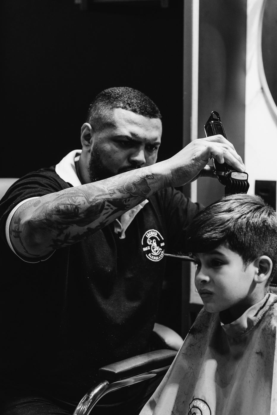Barber giving a young boy a haircut